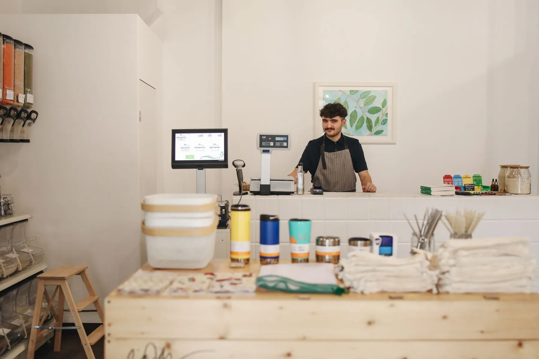Small-business owner standing behind the counter of a refill shop